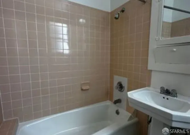 a white toilet sitting next to a bathroom sink