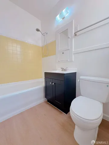 a bathroom with a bathtub sink and mirror