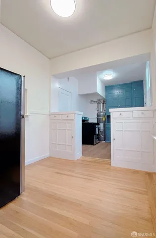 a view of kitchen and refrigerator cabinets