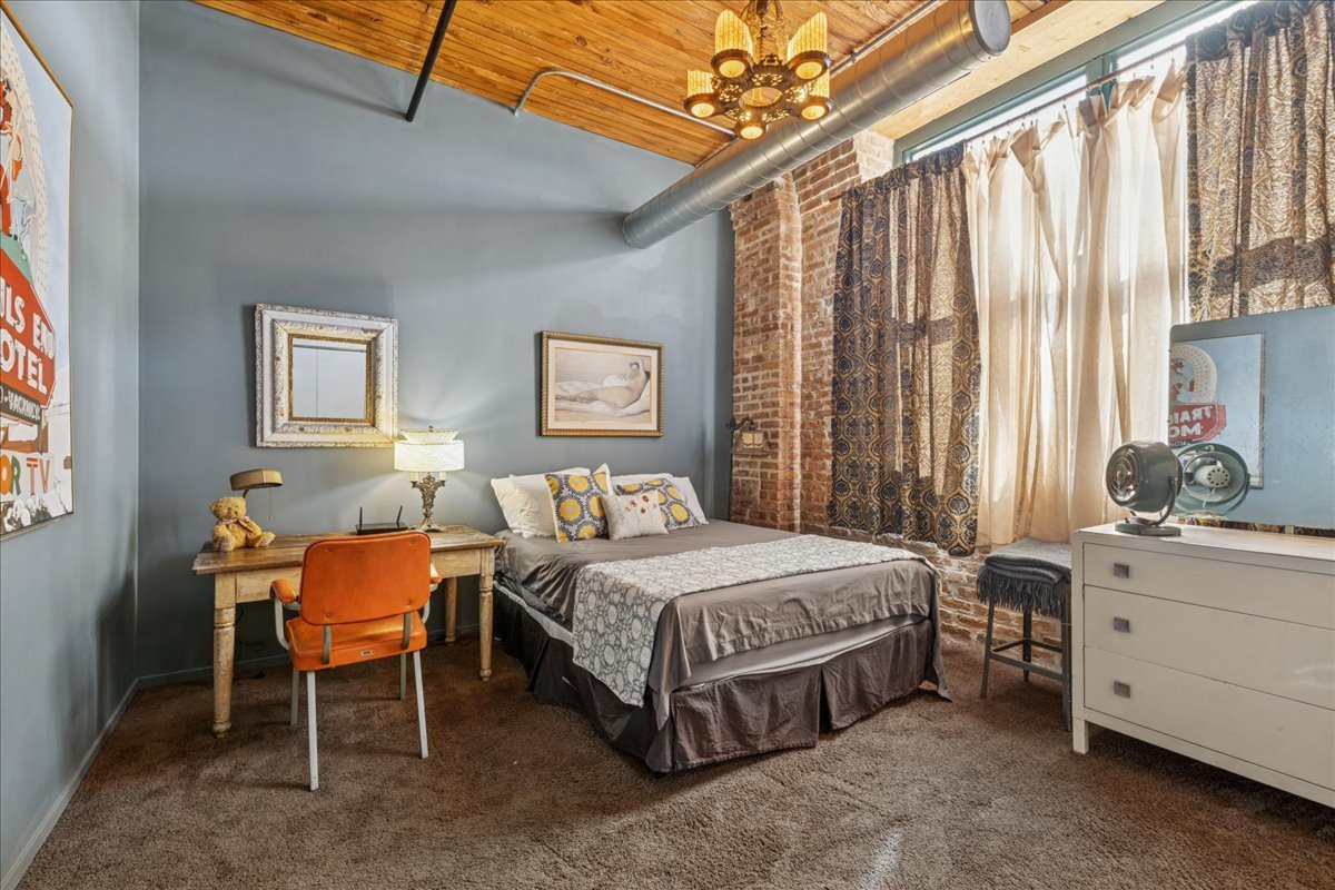 3500 South Sangamon Street, Unit 109 Chicago, IL 60609 - Photo 12 of 23 a bedroom with a bed chair and window