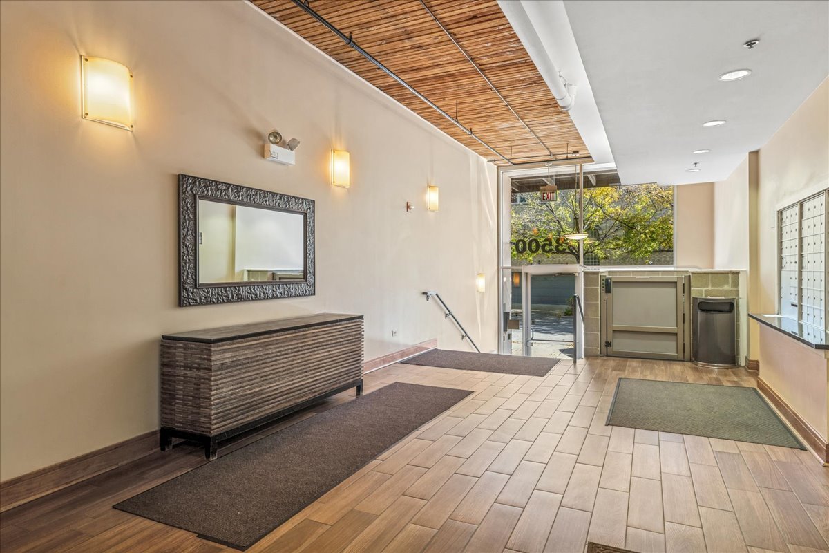 3500 South Sangamon Street, Unit 109 Chicago, IL 60609 - Photo 20 of 23 a room with a balcony a bed and a dresser