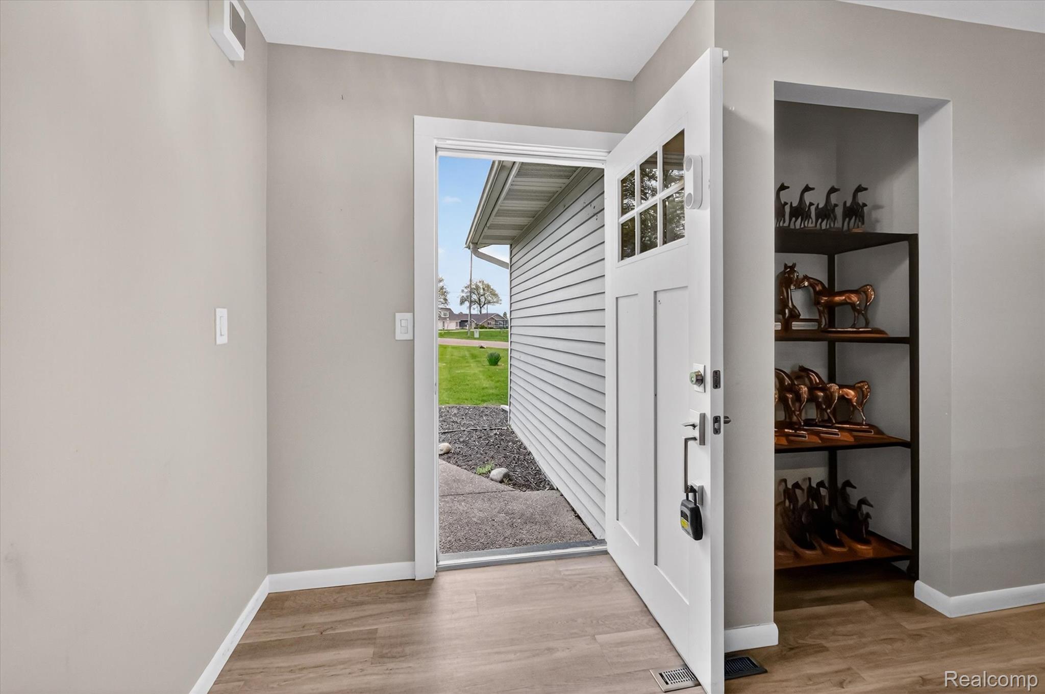 2264 Crane Road Fenton, MI 48430 - Photo 10 of 55 Foyer entrance with light wood-type flooring and baseboards