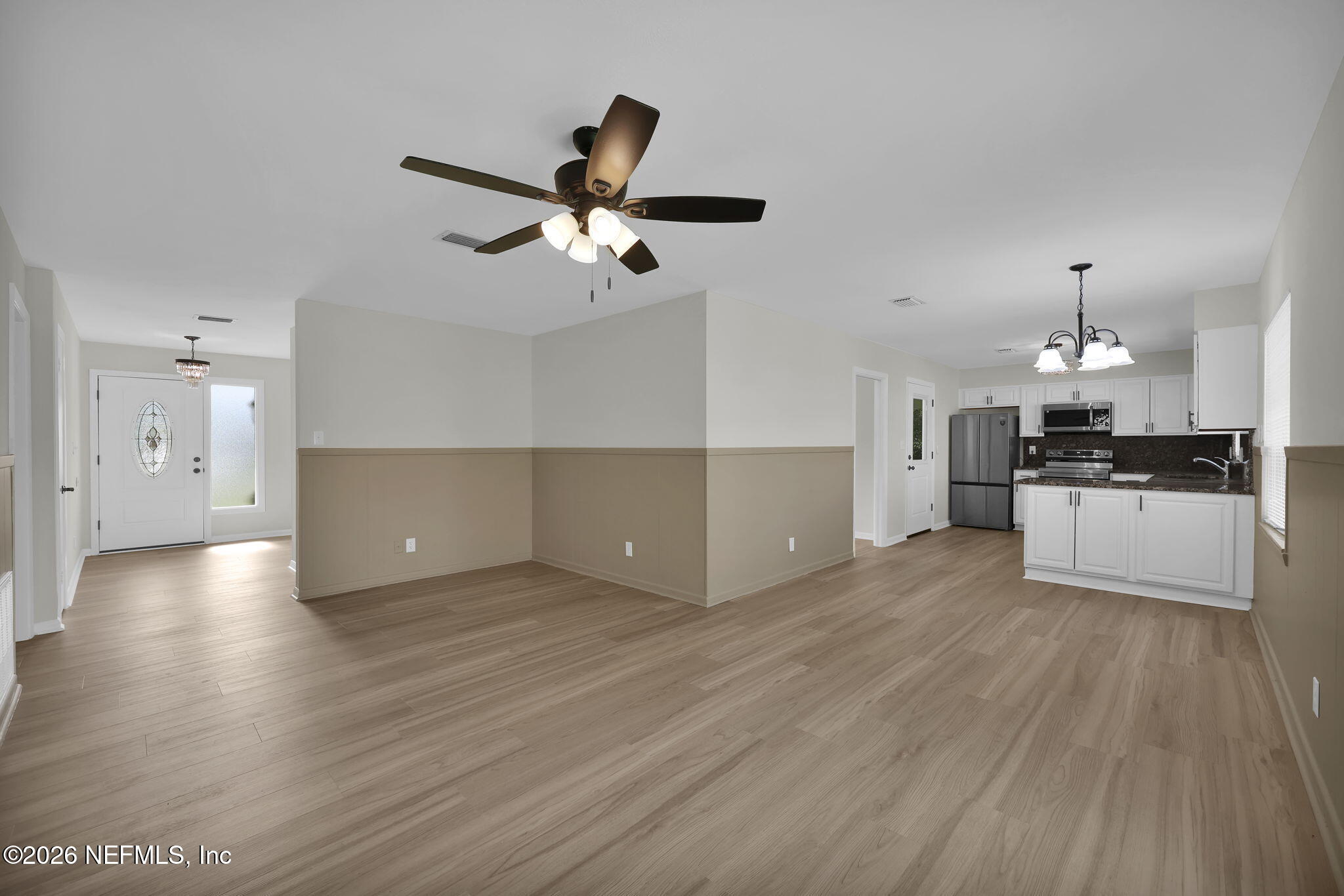 8544 Sanchez Road Jacksonville, FL 32217 - Photo 23 of 46 a view of a kitchen with a sink and dishwasher a refrigerator with wooden floor
