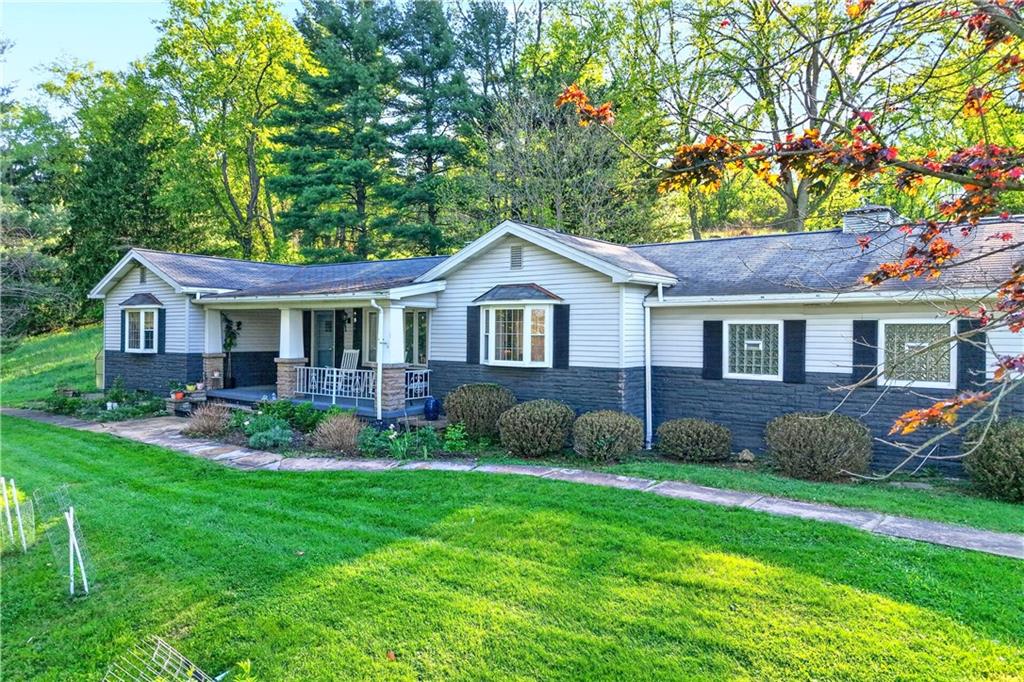 1188 Willowbrook Road Belle Vernon, PA 15012 - Photo 1 of 50 a front view of a house with a yard and green space
