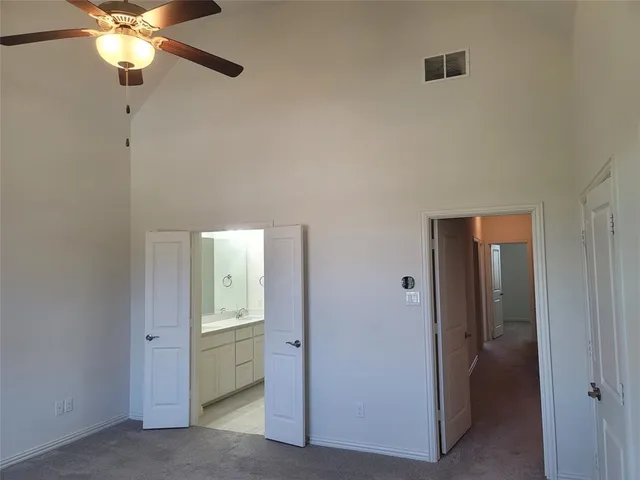 a view of an empty room with a bathroom