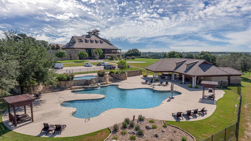 7308 Castle Royle Court Cleburne, TX 76033 - Photo 18 of 35 View of swimming pool with pool water feature, a gazebo, a patio area, and a yard