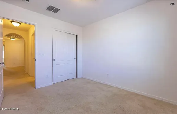 an empty room with closet area
