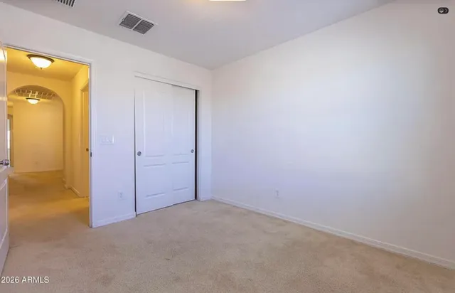 an empty room with closet area