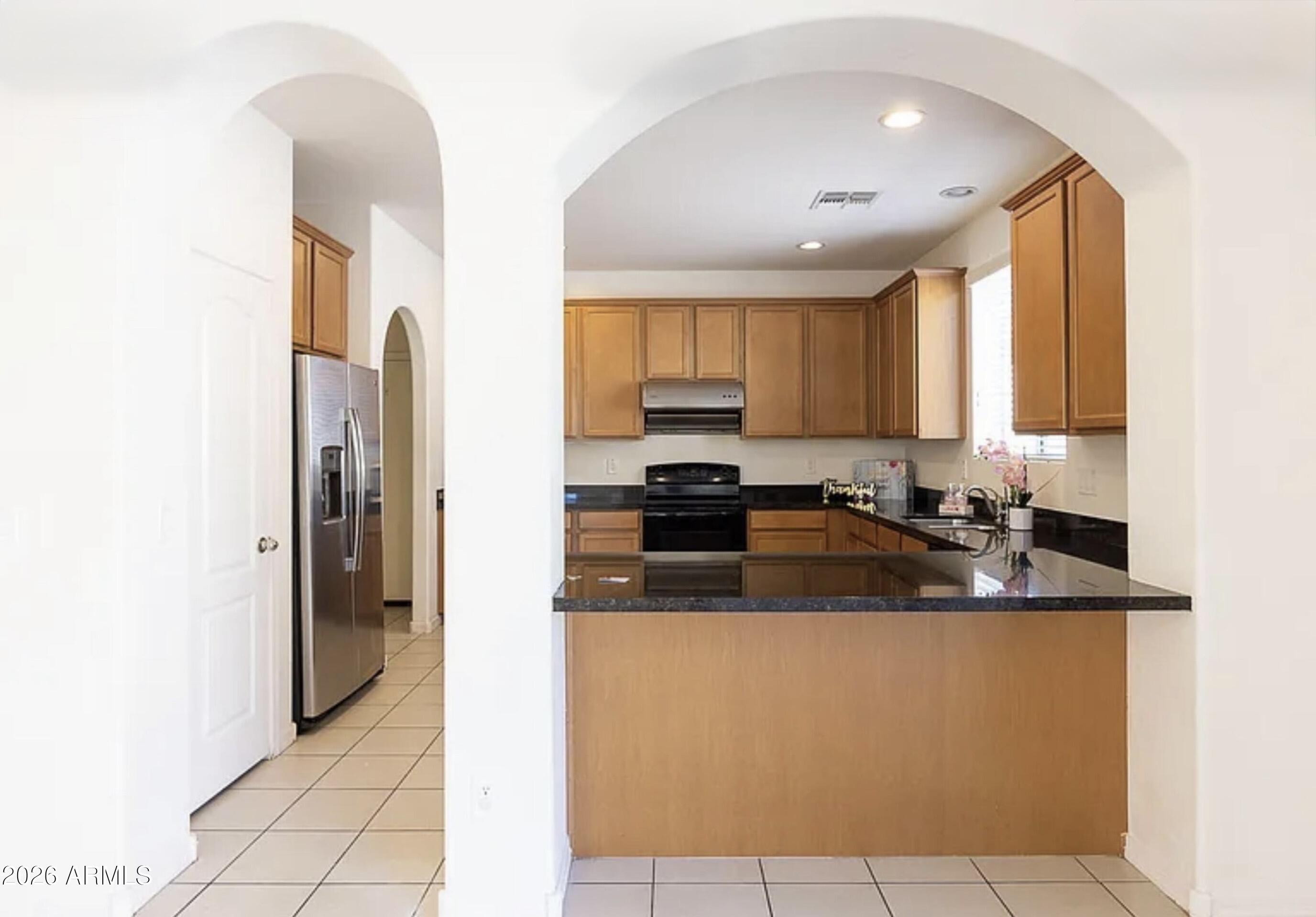 3701 East Hans Drive Gilbert, AZ 85296 - Photo 4 of 12 a kitchen with stainless steel appliances granite countertop a refrigerator and a sink