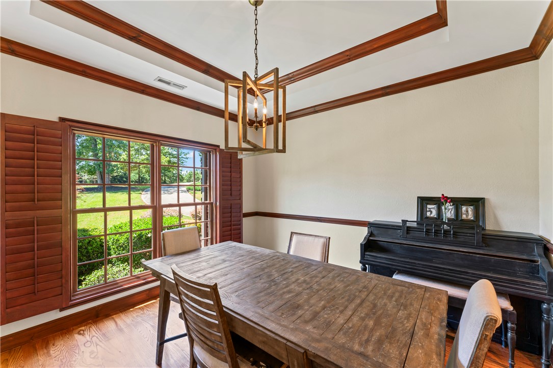 579 Terrapin Crossing Road Pickens, SC 29671 - Photo 13 of 50 Hardwood floors and tray ceiling define this elegant dining space with a natural light.
