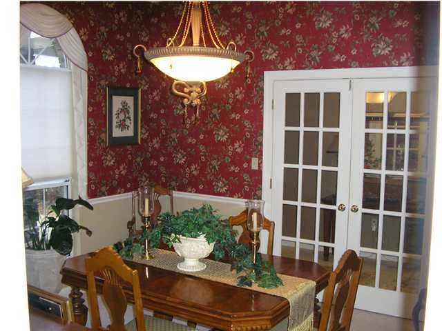 2594 Cove Road Navarre, FL 32566 - Photo 8 of 18 a view of a dining room with furniture window and wooden floor