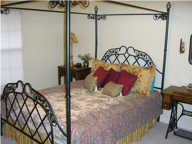 2594 Cove Road Navarre, FL 32566 - Photo 10 of 18 a bedroom with a bed and a view of bathroom