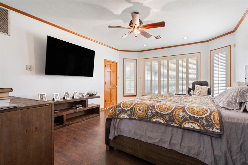 564 Sam Bass Road McGregor, TX 76657 - Photo 15 of 37 Spacious room with dark wood-finish flooring, white walls, and warm wood trim