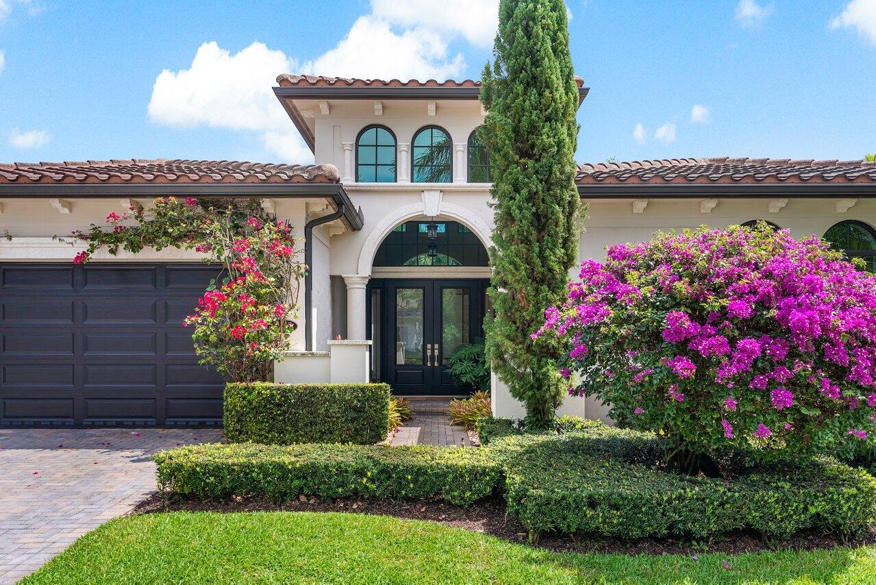 17662 Cadena Drive Boca Raton, FL 33496 - Photo 25 of 71 a front view of a house with a garden
