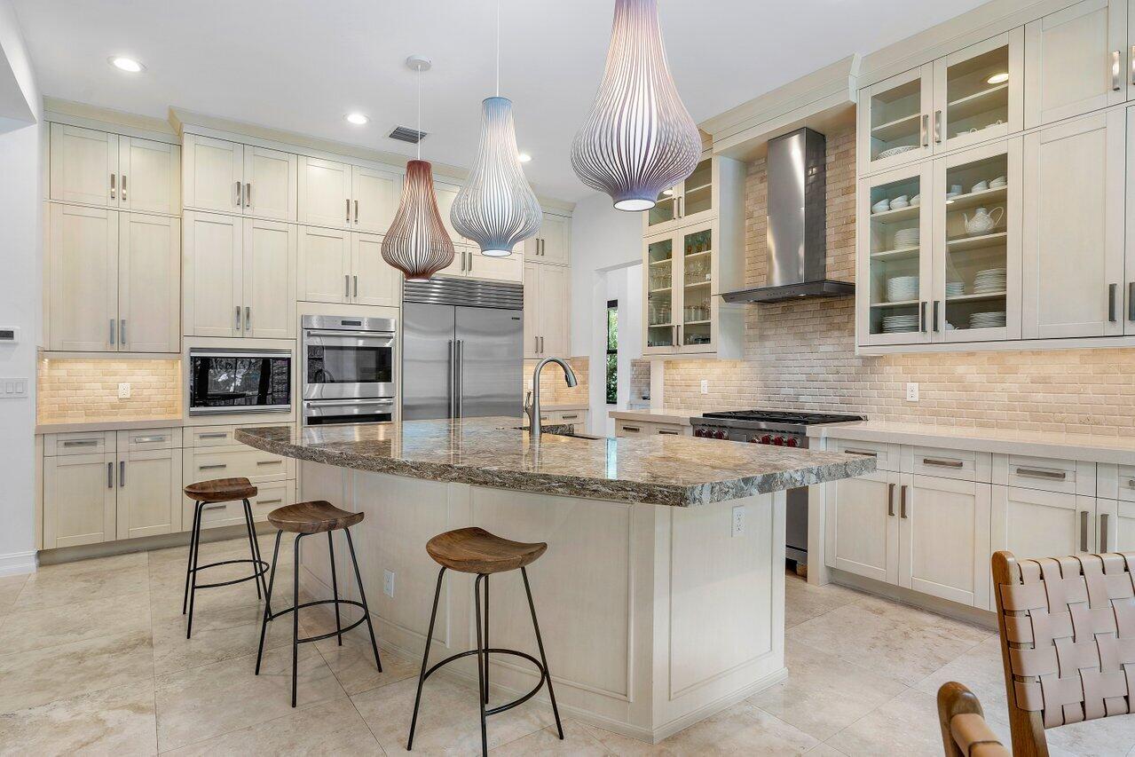 17662 Cadena Drive Boca Raton, FL 33496 - Photo 31 of 71 a kitchen with stainless steel appliances granite countertop a stove and cabinets