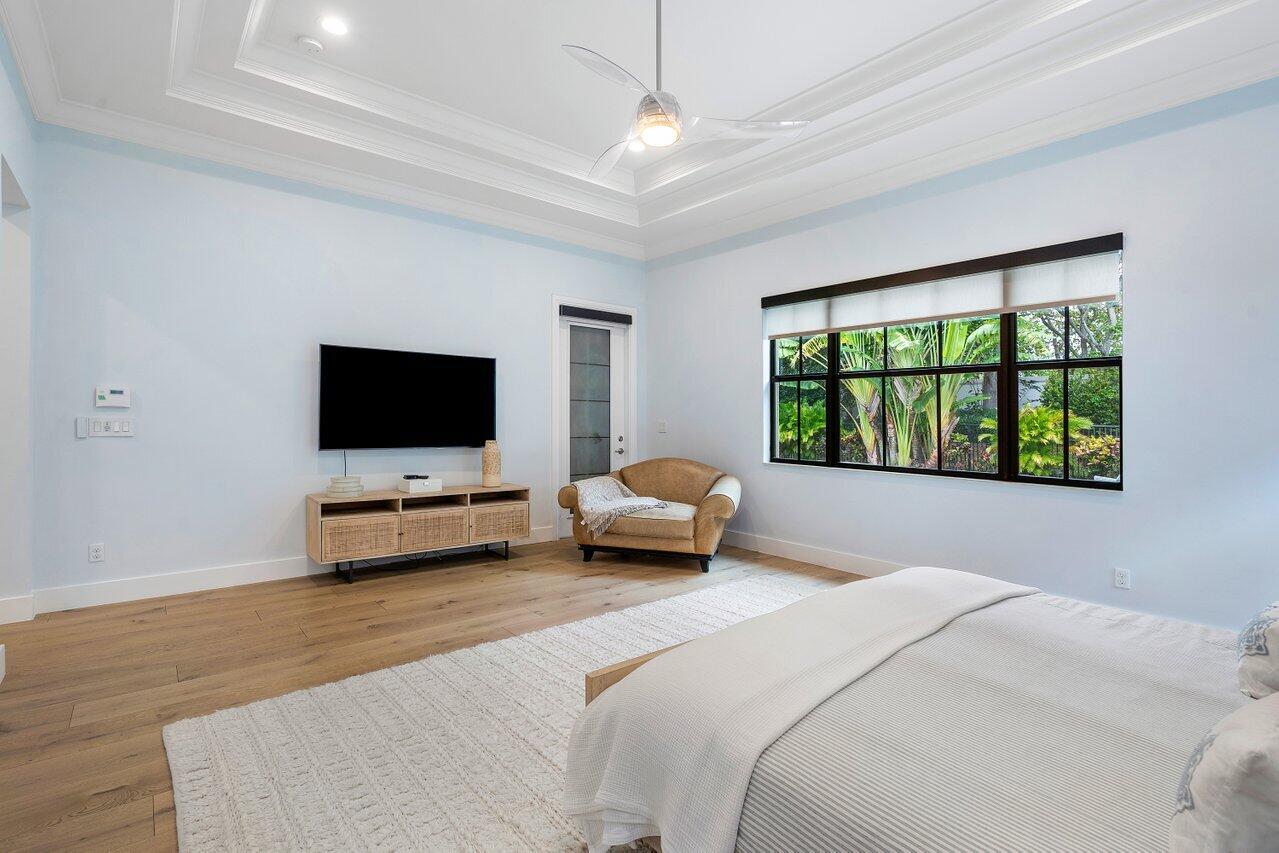 17662 Cadena Drive Boca Raton, FL 33496 - Photo 40 of 71 a bedroom with a bed and a flat screen tv