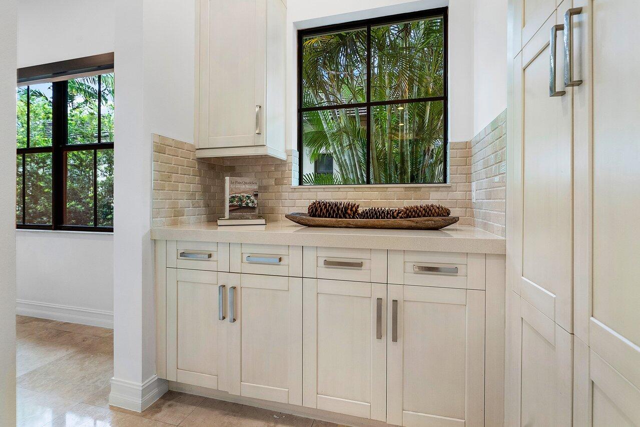 17662 Cadena Drive Boca Raton, FL 33496 - Photo 48 of 71 a kitchen with white cabinets and a window