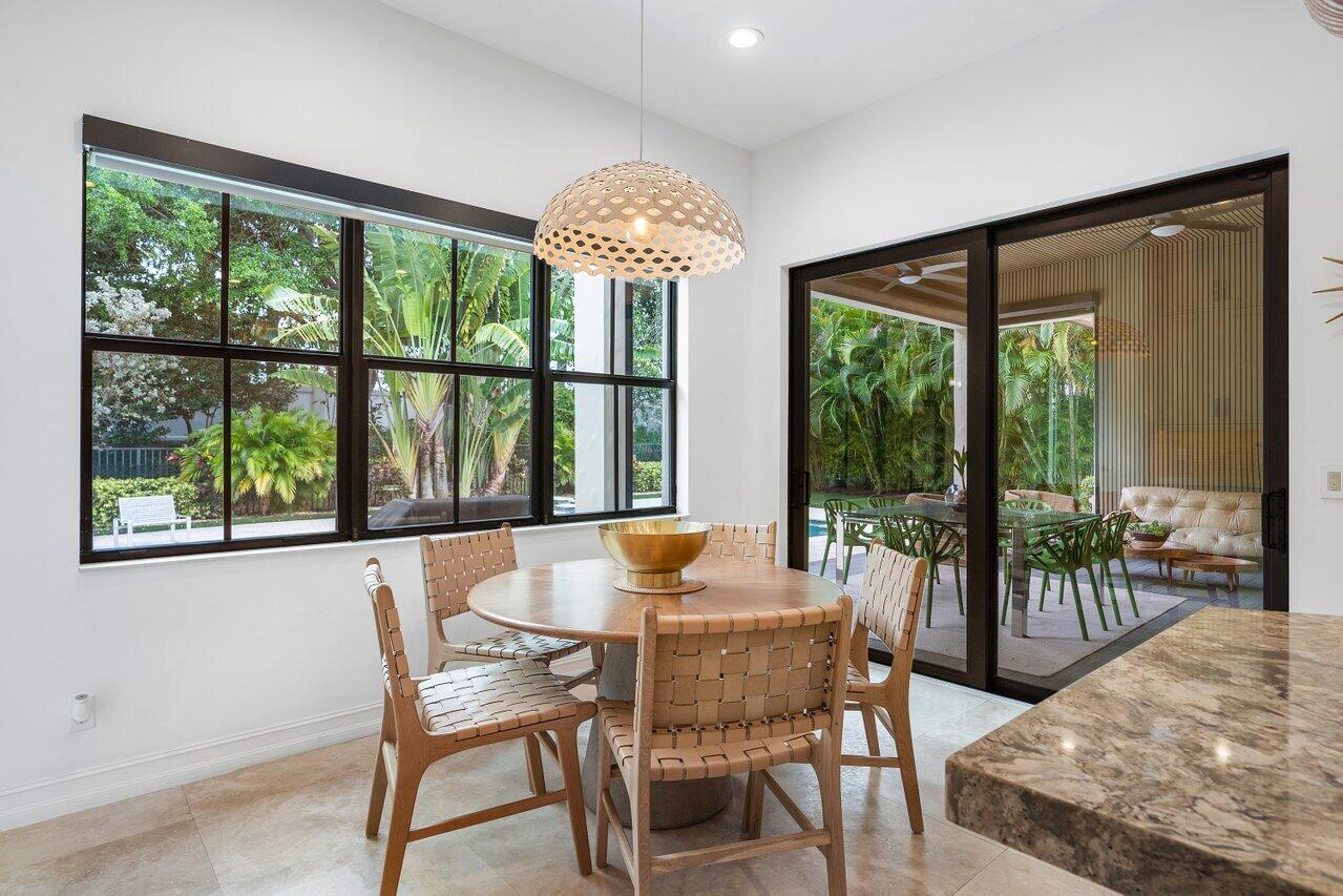 17662 Cadena Drive Boca Raton, FL 33496 - Photo 6 of 71 a dining room with furniture large windows and wooden floor