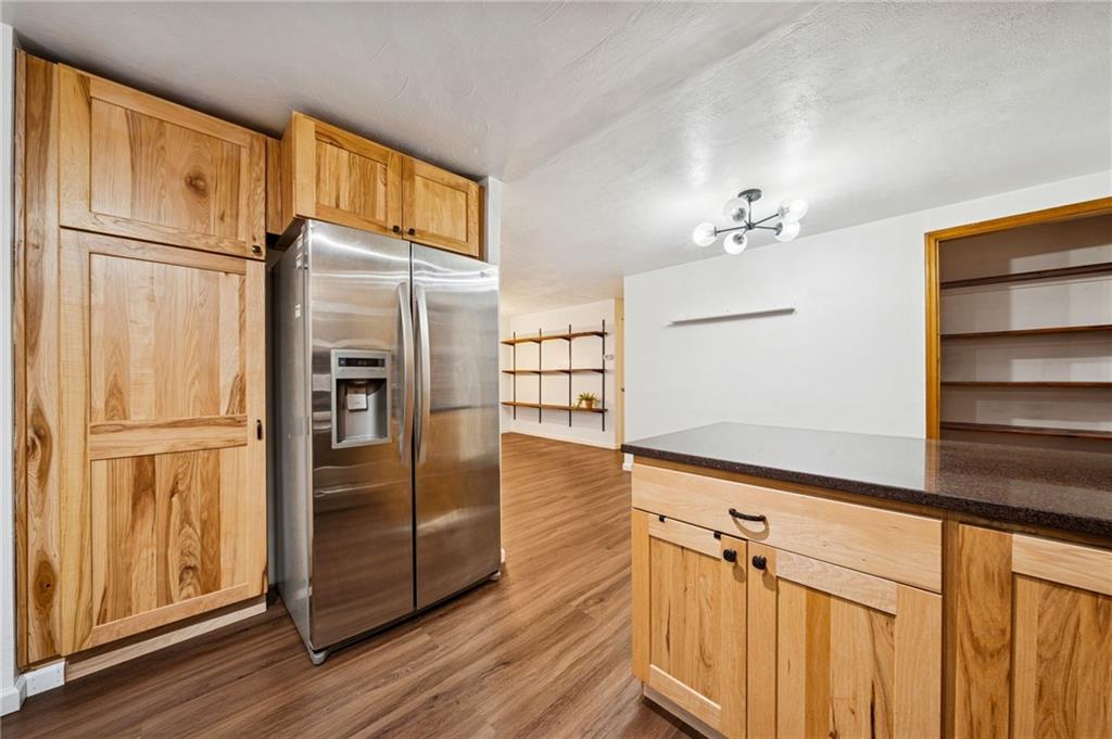 910 Colonial Manor Road Irwin, PA 15642 - Photo 15 of 40 a kitchen with stainless steel appliances a refrigerator and wooden floor