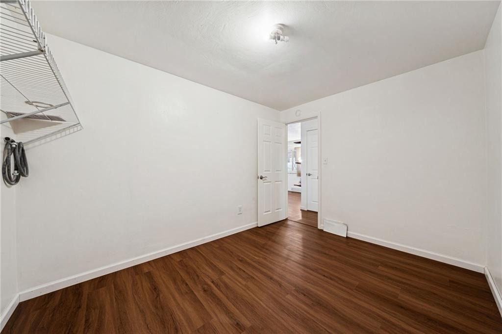 910 Colonial Manor Road Irwin, PA 15642 - Photo 24 of 40 a view of a room with wooden floor and white walls