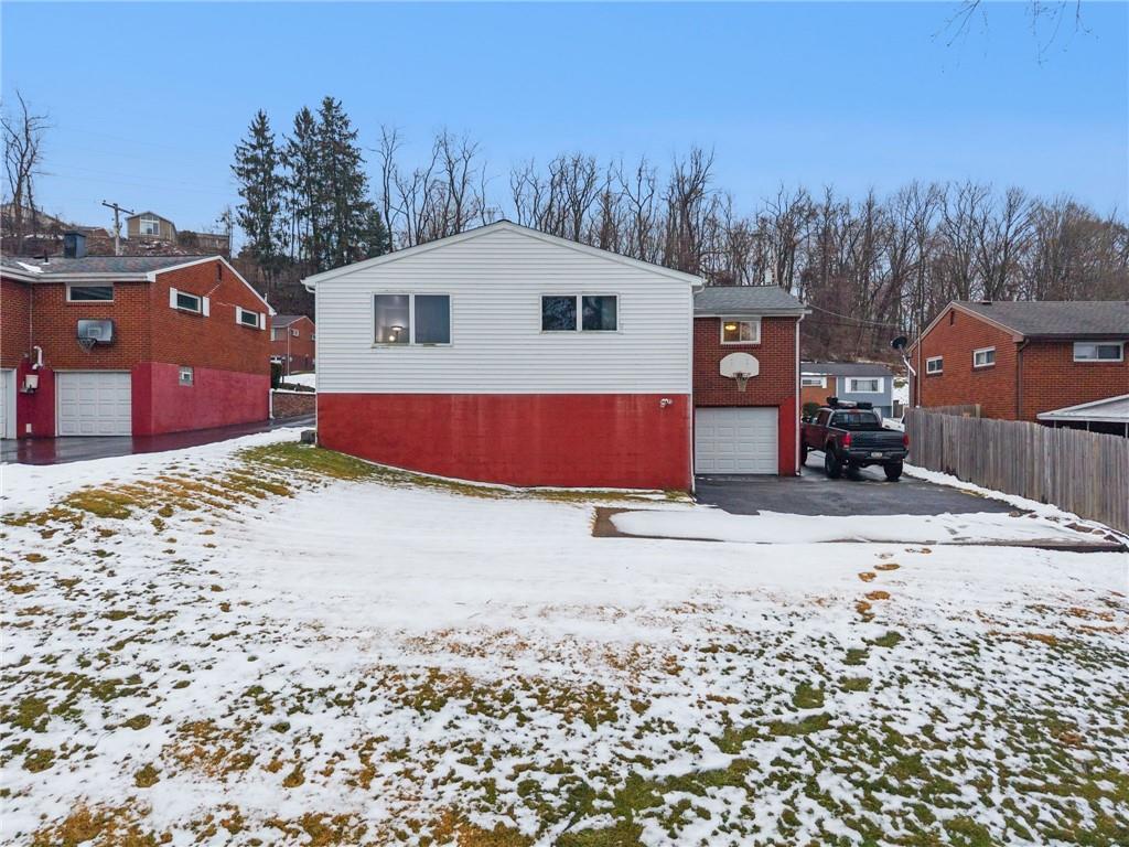 910 Colonial Manor Road Irwin, PA 15642 - Photo 31 of 40 a front view of a house with a yard covered with snow in front of house