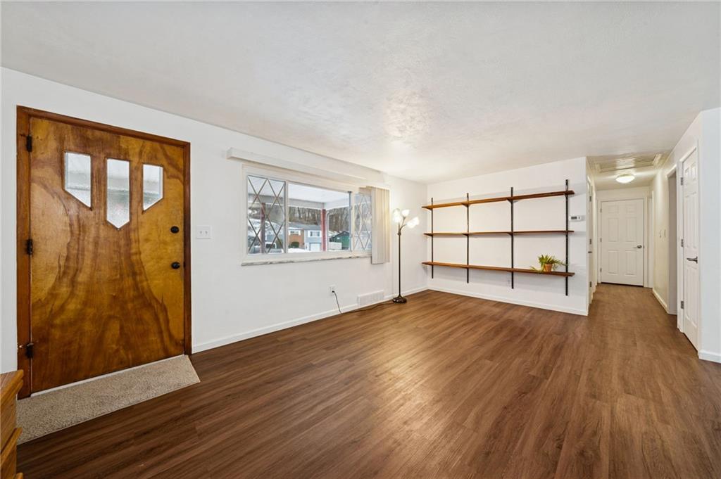 910 Colonial Manor Road Irwin, PA 15642 - Photo 6 of 40 a view of empty room with wooden floor and fan
