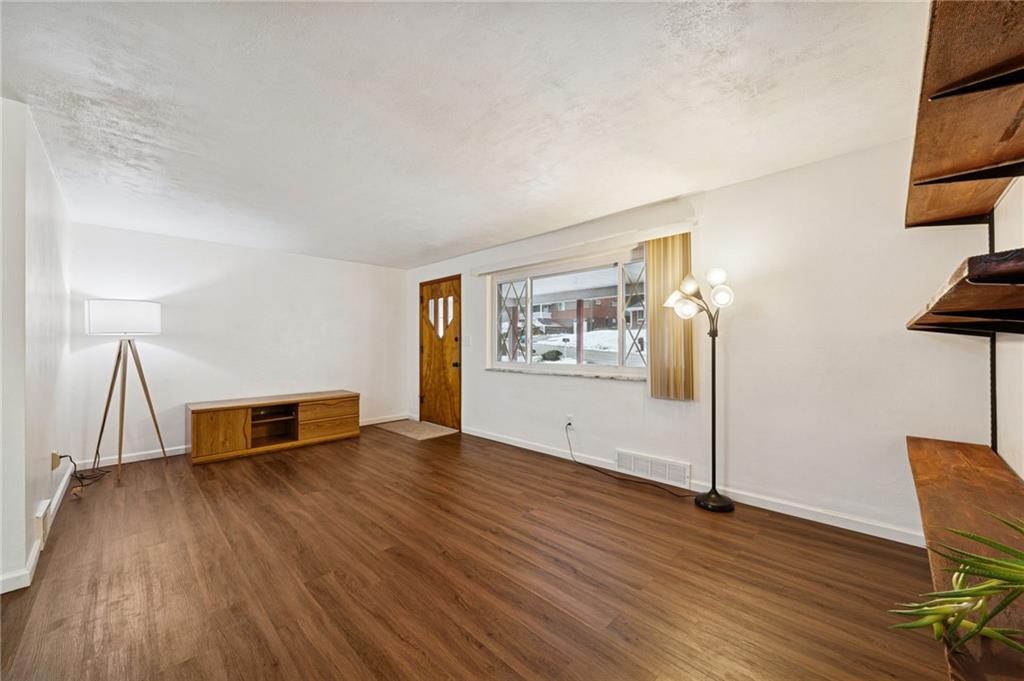 910 Colonial Manor Road Irwin, PA 15642 - Photo 9 of 40 a living room with hard wood floors and a wooden floor