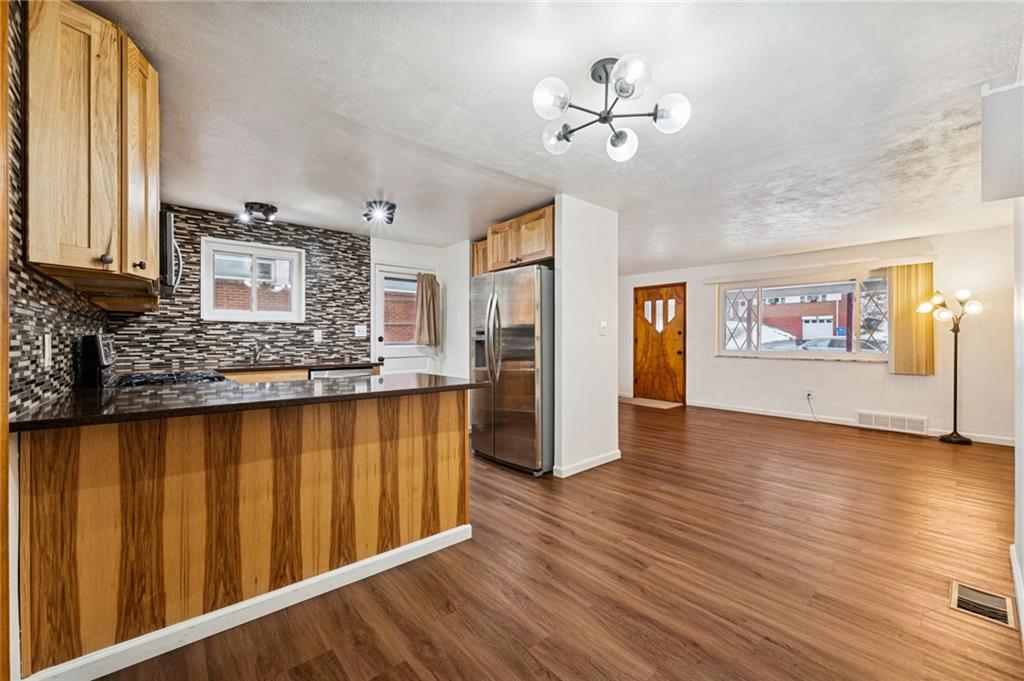 910 Colonial Manor Road Irwin, PA 15642 - Photo 10 of 40 a view of a living room with hardwood floor and a ceiling fan