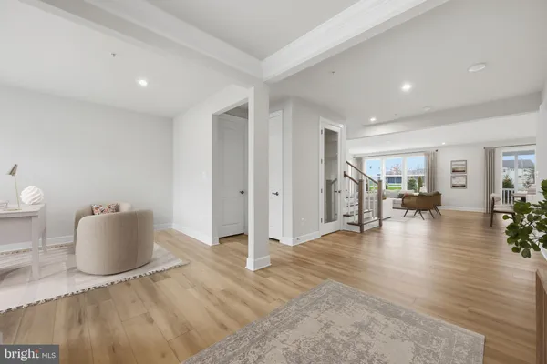 a view of a livingroom with wooden floor and furniture