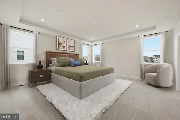 a bedroom with a large bed and a couch