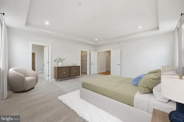 a spacious bedroom with a bed and a couch