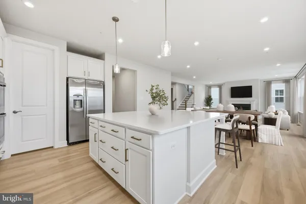 a large kitchen with stainless steel appliances kitchen island a island in the center