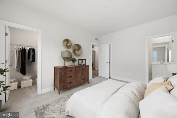 a bedroom with a bed and a dresser