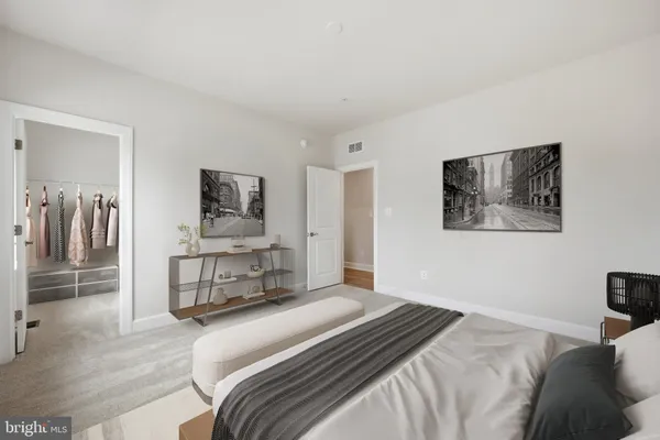 a bedroom with a bed and a view of kitchen