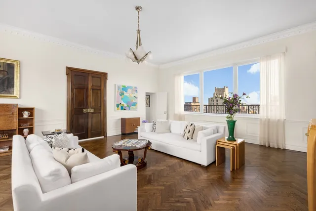 a living room with furniture dining area and a chandelier