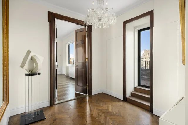 a view of a dining room with furniture and chandelier
