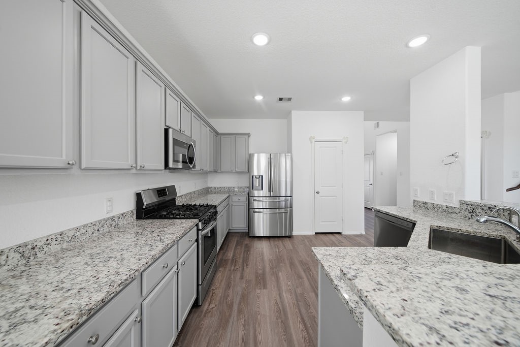14230 Overbrook Willow Way Rosharon, TX 77583 - Photo 17 of 50 a kitchen with a stove sink and refrigerator
