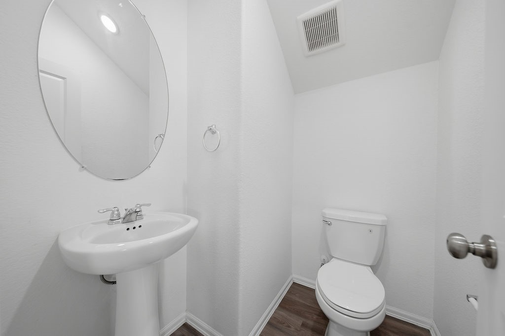 14230 Overbrook Willow Way Rosharon, TX 77583 - Photo 25 of 50 a bathroom with a toilet sink and mirror