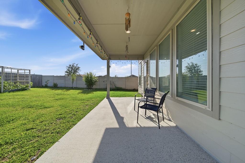 14230 Overbrook Willow Way Rosharon, TX 77583 - Photo 43 of 50 a view of a patio with a table chairs and a yard