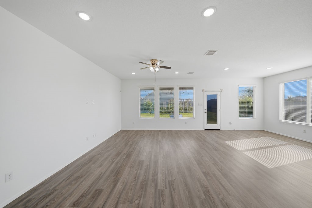 14230 Overbrook Willow Way Rosharon, TX 77583 - Photo 8 of 50 an empty room with wooden floor and windows
