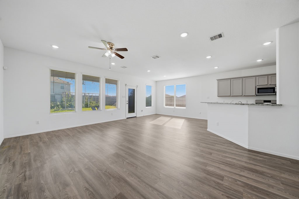 14230 Overbrook Willow Way Rosharon, TX 77583 - Photo 10 of 50 a view of an empty room with wooden floor and a window