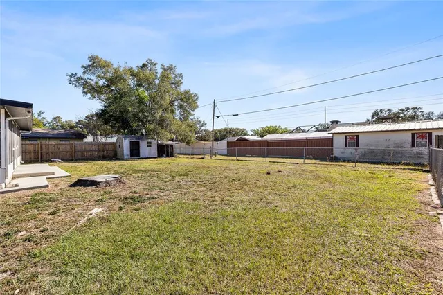 an aerial view of residential building with parking and space