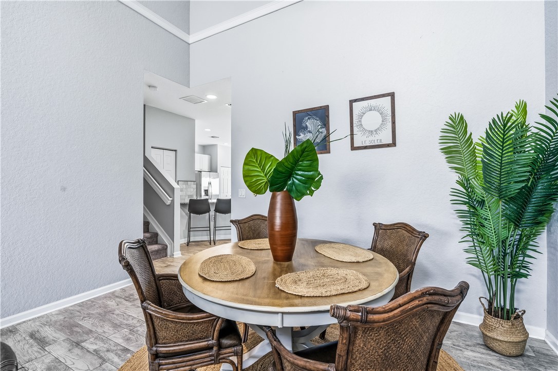 2522 Stockbridge Square Southwest Vero Beach, FL 32962 - Photo 12 of 34 a dining room with furniture and potted plant