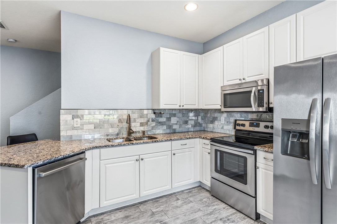 2522 Stockbridge Square Southwest Vero Beach, FL 32962 - Photo 15 of 34 a kitchen with a sink stove and microwave