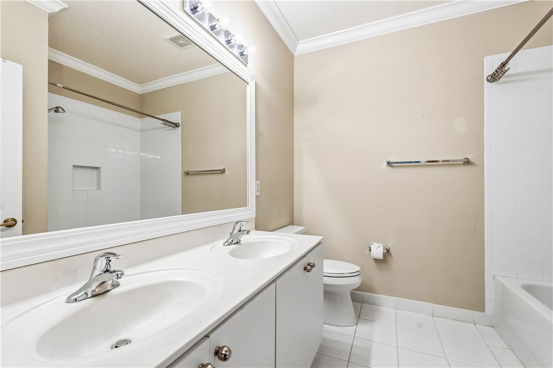 2522 Stockbridge Square Southwest Vero Beach, FL 32962 - Photo 29 of 34 a bathroom with a double vanity sink toilet and a mirror