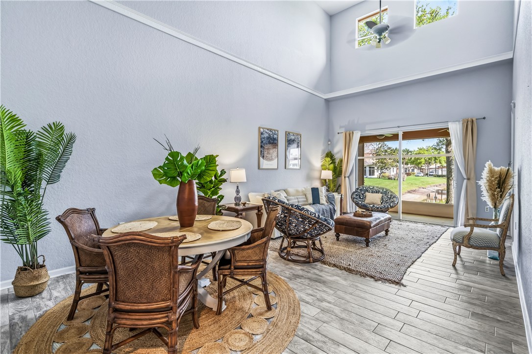 2522 Stockbridge Square Southwest Vero Beach, FL 32962 - Photo 6 of 34 a dining room with furniture potted plants and wooden floor