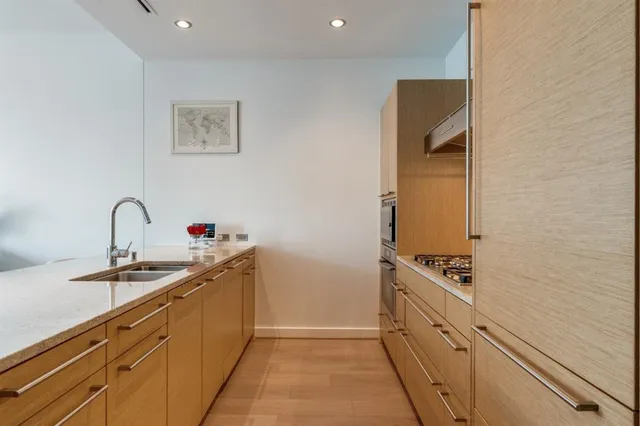 a kitchen with stainless steel appliances granite countertop a sink and cabinets