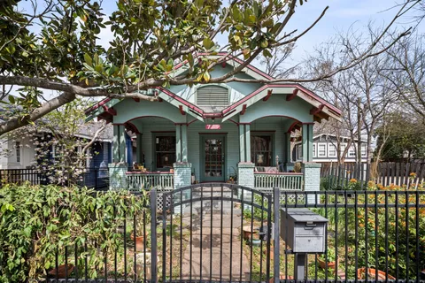 a front view of a house with a garden