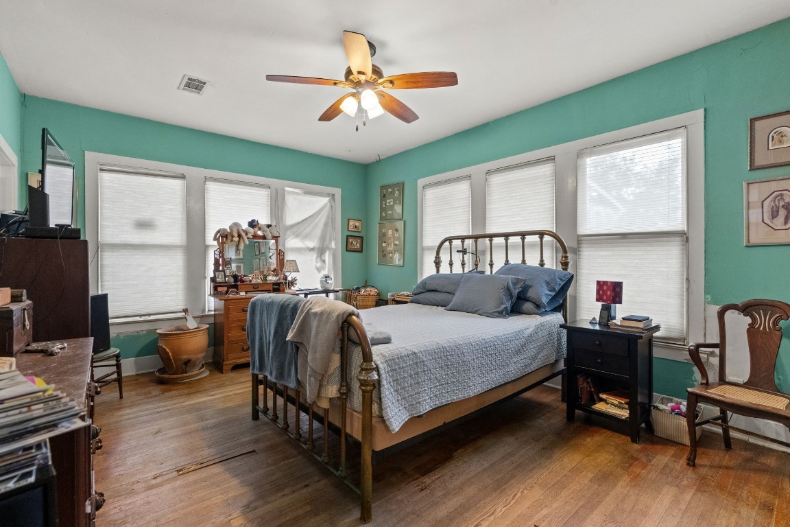 1004 Missouri Street Houston, TX 77006 - Photo 12 of 22 a bedroom with a bed and a chandelier