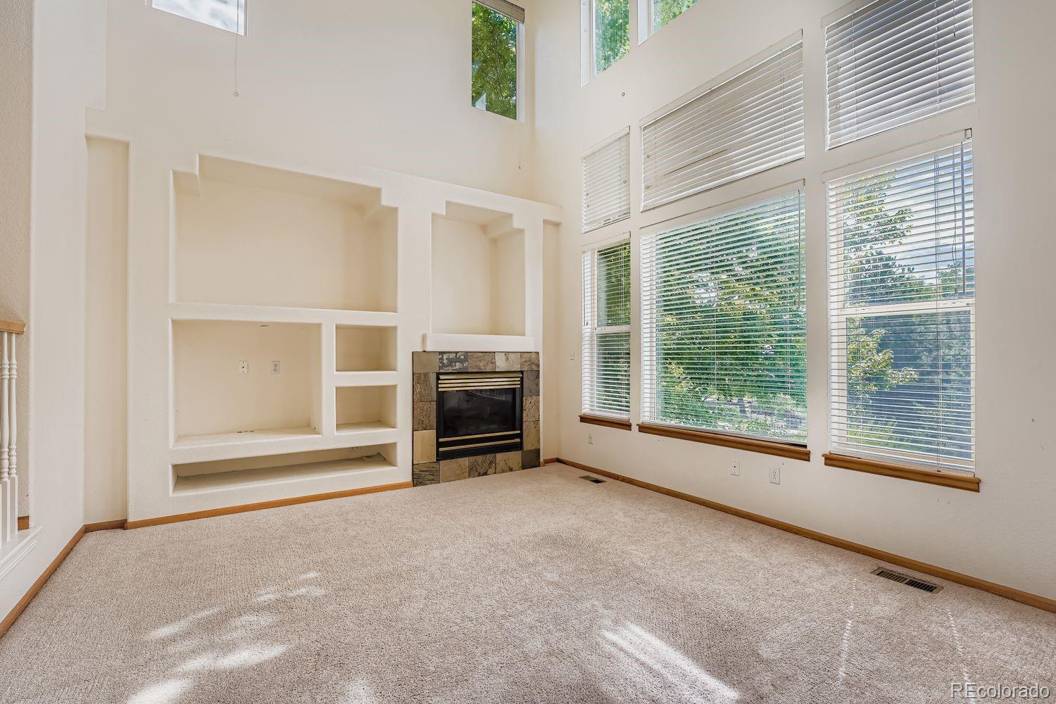 20758 East Maplewood Lane Centennial, CO 80016 - Photo 11 of 29 a view of a livingroom with an empty space and a fireplace